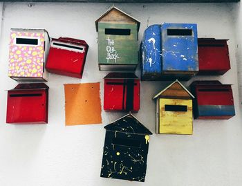 Low angle view of colorful mailboxes hanging on wall