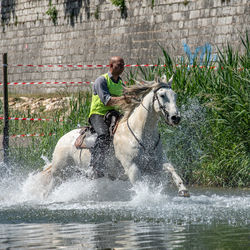 Side view of man splashing water