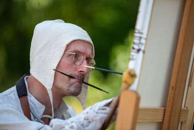 Portrait of man holding eyeglasses