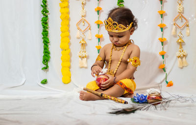 Adorable infant dressed as hindu god krishna on the occasion of janmashtami celebrated at india