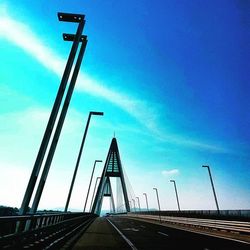 Road leading towards blue sky