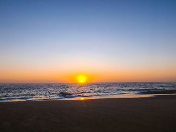 Scenic view of sea against clear sky during sunset