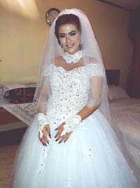 Portrait of smiling young bride at home