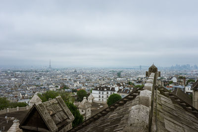 High angle view of city buildings against cloudy sky in paris, france
