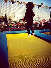 Full length of boy against sky in city