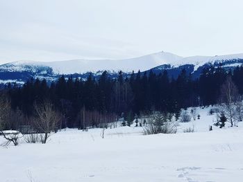 Scenic view of snow covered landscape against sky