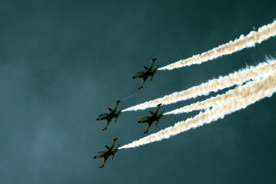 Low angle view of airshow against sky