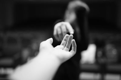 People reaching out while standing outdoors