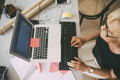 Aerial view of woman working in office at home