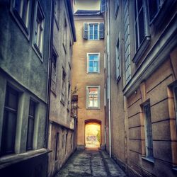 Narrow alley amidst buildings in city