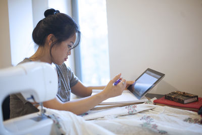 Young woman working on a tablet pc