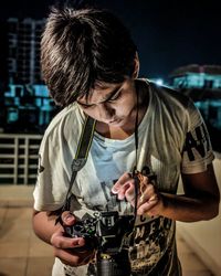 Young man photographing with camera