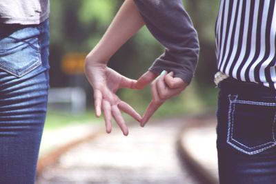 Cupids making heart shape with hands 