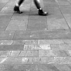 Low section of people standing on tiled floor