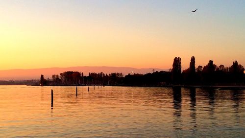 Scenic view of lake against sky during sunset