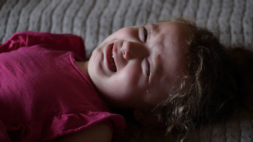 Portrait of girl sleeping on bed