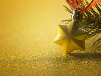 Close-up of christmas ornaments hanging on tree