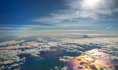 Aerial view of clouds over landscape against sky