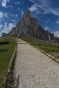 Road leading towards mountain against sky