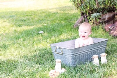 A boy plays in the bath outside.