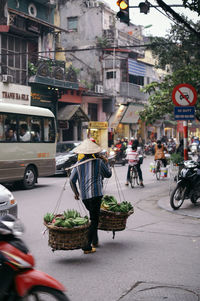 Vendor carrying bananas in basket