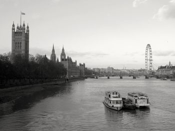 View of buildings in river with city in background