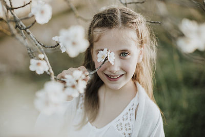 Portrait of smiling girl with flowers