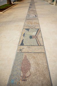 High angle view of tiled floor by footpath