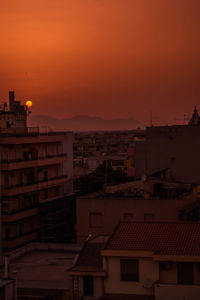 High angle view of buildings against sky during sunset