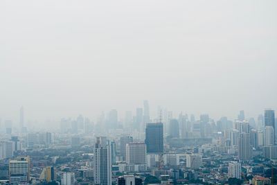 Buildings in city against clear sky