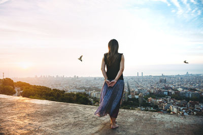 Spain, barcelona, woman looking at view over city