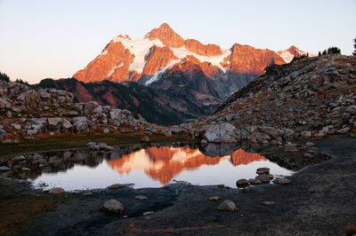 Scenic view of lake and mountains against sky