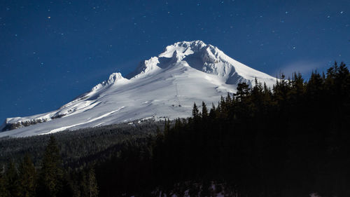 Scenic view of snowcapped mountains against clear blue sky