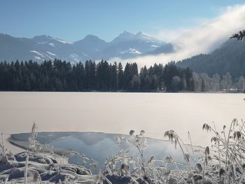 Scenic view of lake and mountains against sky