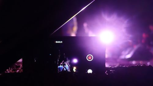 Low angle view of lighting equipment at night