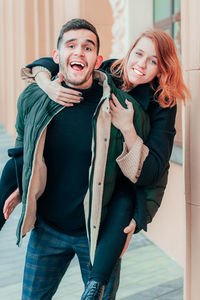 Portrait of young couple standing outdoors