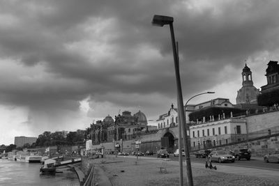 Buildings in city against cloudy sky