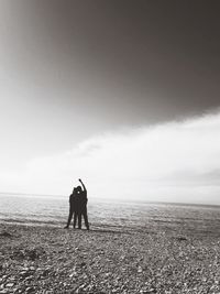 Silhouette of people standing on beach