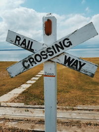 Information sign on road against sky