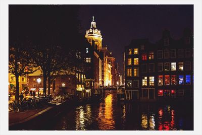 Reflection of illuminated buildings in water at night