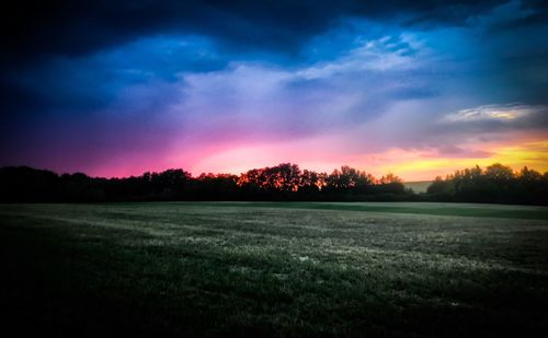 Scenic view of field against sky during sunset
