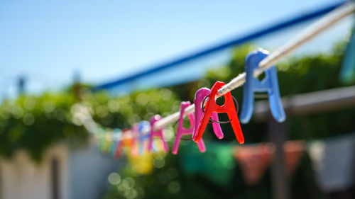 Close-up of clothespins hanging on clothesline