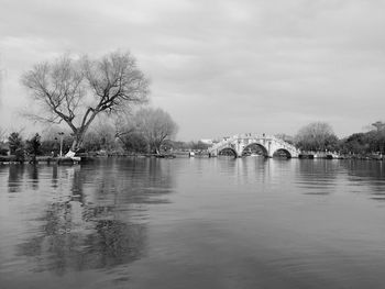 View of bridge over river against cloudy sky