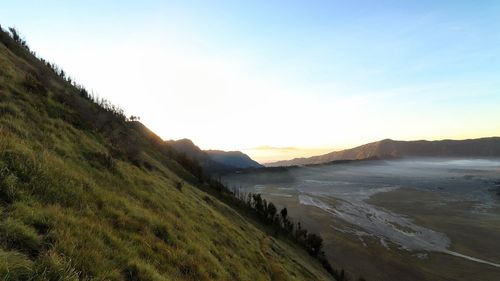 Scenic view of beach against sky during sunset