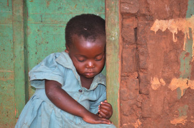 Close-up of baby girl sitting outdoors