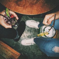 Low section of people holding drink