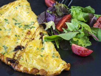 High angle view of omelet and vegetables served in plate