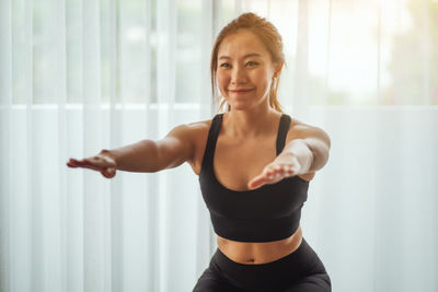 Young woman exercising in gym