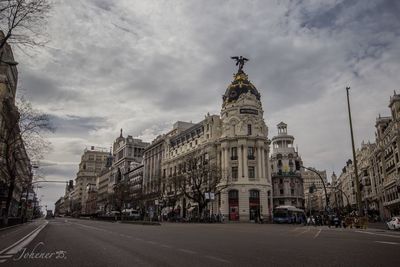 View of city street and buildings against sky