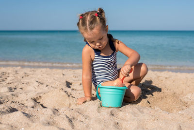 Girl playing in sand at beach